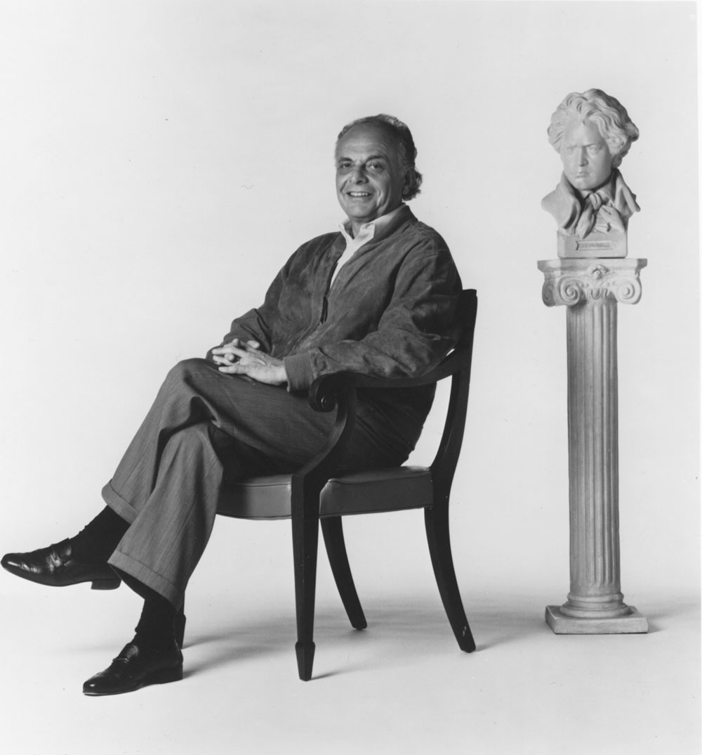 This photograph shows Maazel (c. mid-1990s) posing with a bust of Beethoven. Photograph by Karen Meyers, date unknown.