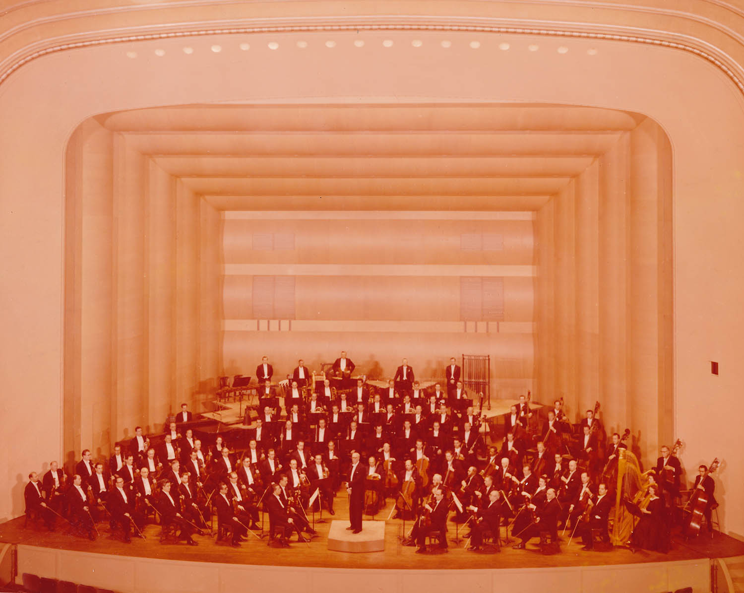 The Cleveland Orchestra and George Szell pose in the newly renovated Concert Hall. Unknown photographer, 1958. 