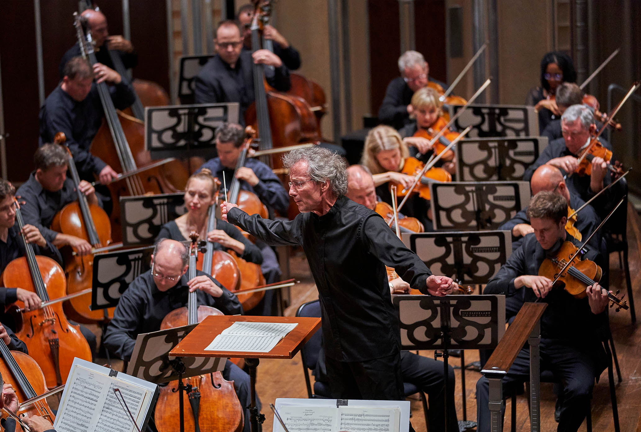 Franz is conducting the Orchestra. Franz and the Orchestra all look very intent.