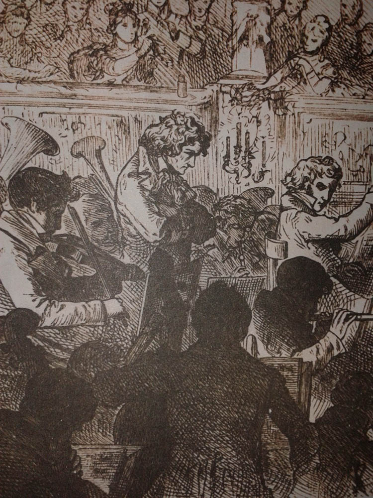 Beethoven stands in the middle of an orchestra as he conducts them in his Ninth Symphony.  