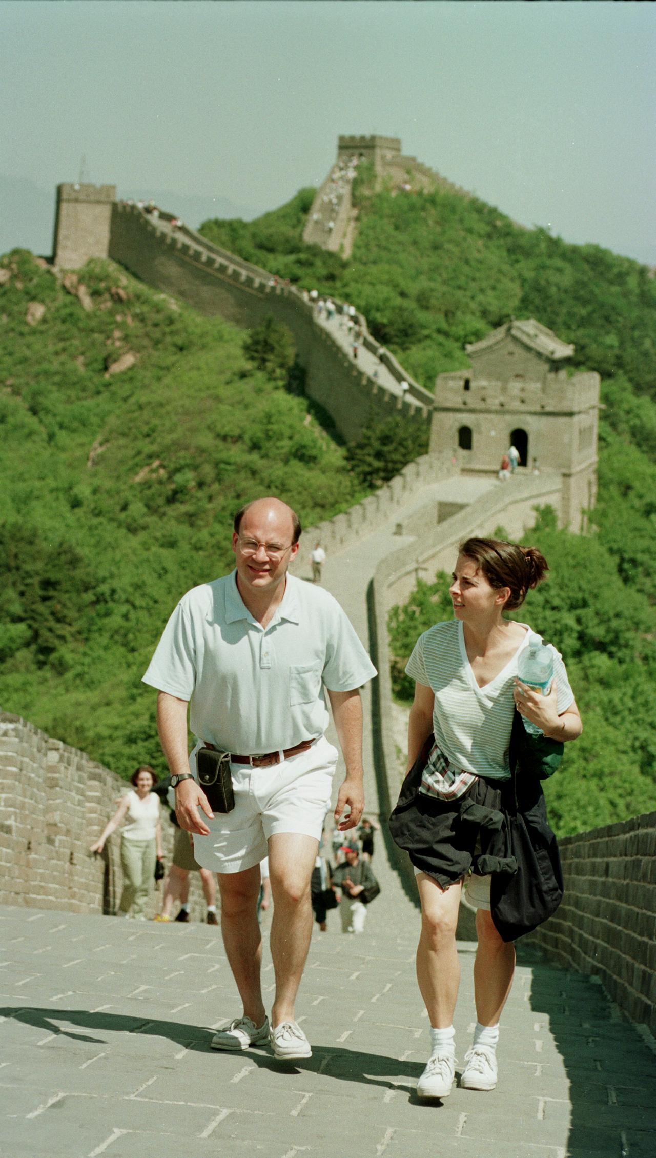 Orchestra musicians walk along the Great Wall of China while sightseeing during the 1998 tour.