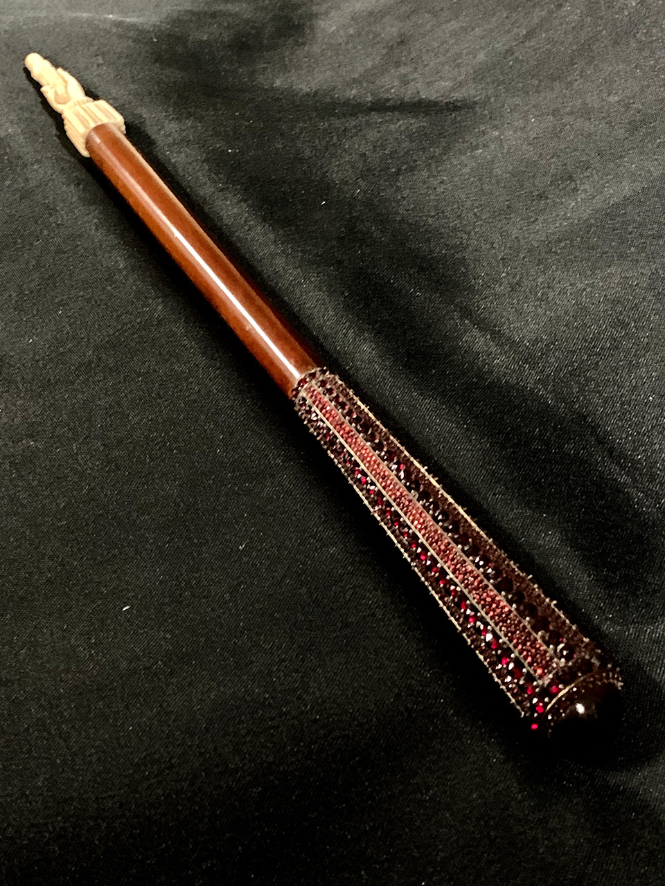 In this photo of the same piece, the baton’s 1,200 bohemian garnets appear in the foreground.