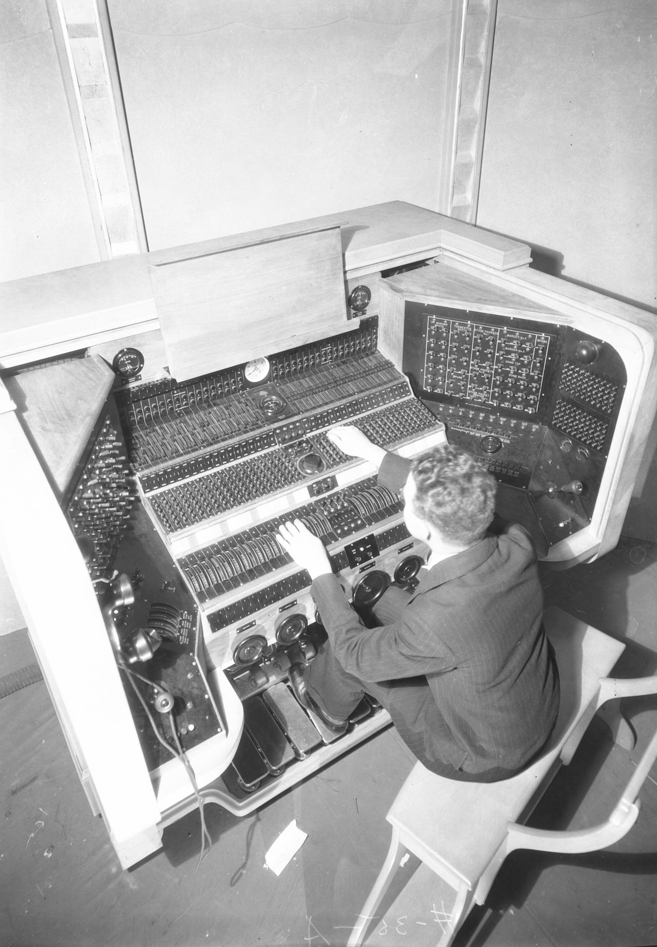 An engineer manipulates lights at the color organ in this 1931 photograph from Severance.